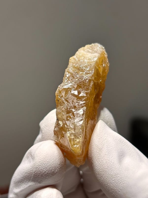 Orange scheelite floater from Xuebaoding, Sichuan, China, view 5 of 5