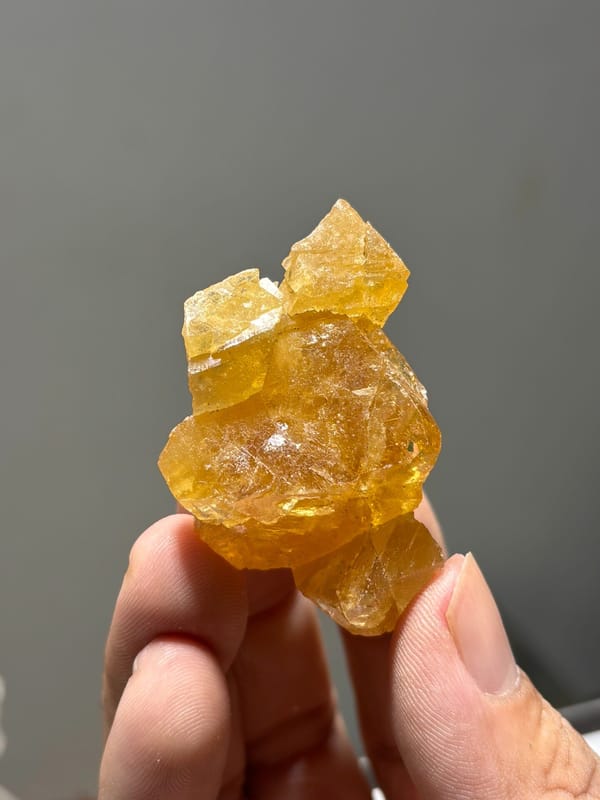 Orange scheelite crystal group from Xuebaoding, Sichuan, China, close-up of the crystal faces