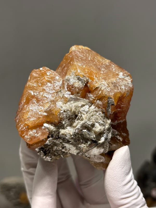 Large orange scheelite crystal group from Xuebaoding, Sichuan, China, close-up of the crystal faces