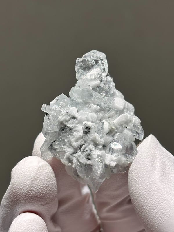 Pale aquamarine cluster on white feldspar from Xuebaoding, Sichuan, China