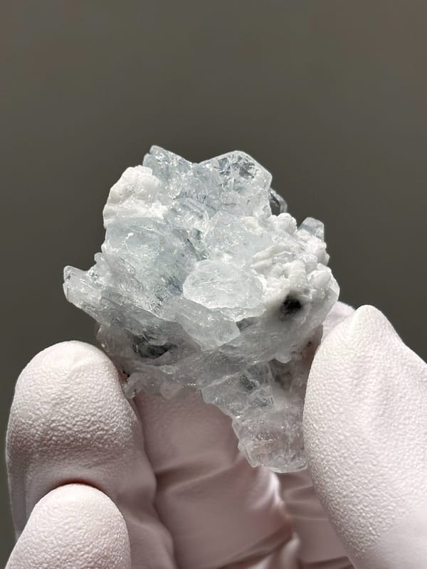 Pale aquamarine cluster on white feldspar from Xuebaoding, Sichuan, China, view 2 of 5