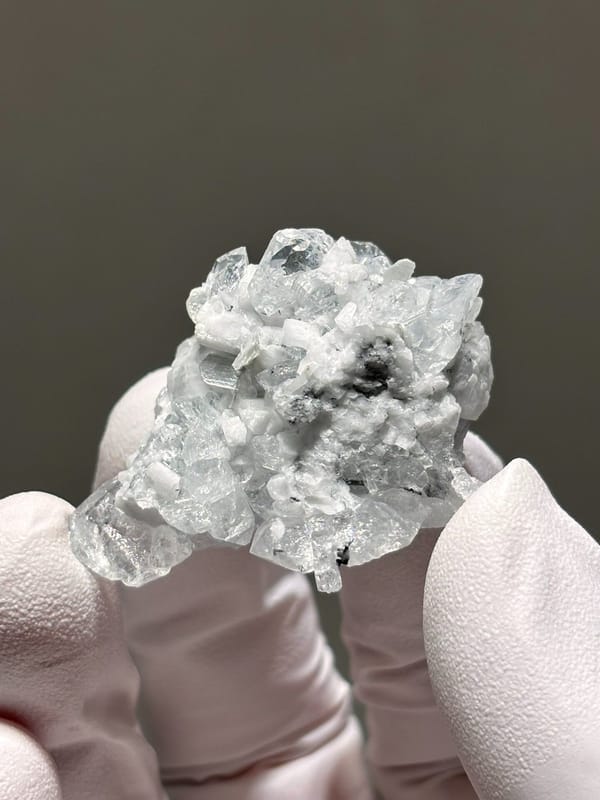 Pale aquamarine cluster on white feldspar from Xuebaoding, Sichuan, China, view 3 of 5