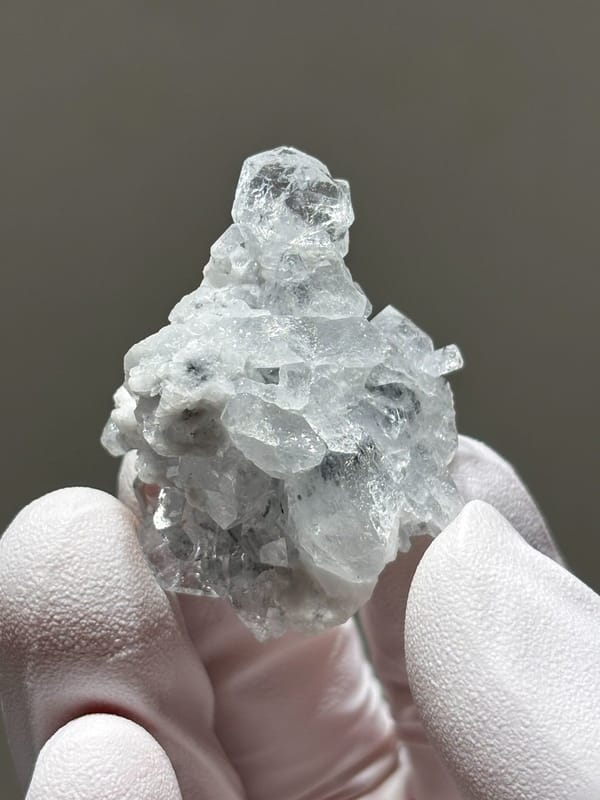 Pale aquamarine cluster on white feldspar from Xuebaoding, Sichuan, China, view 4 of 5