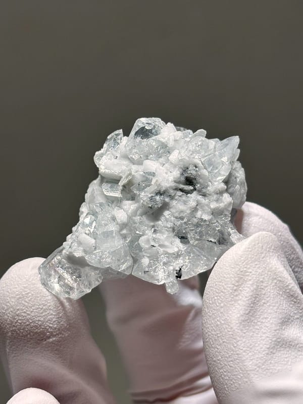 Pale aquamarine cluster on white feldspar from Xuebaoding, Sichuan, China, view 5 of 5