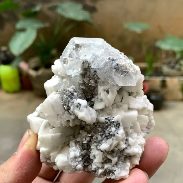 Pale aquamarine crystal on white feldspar with mica from Xuebaoding, Sichuan, China