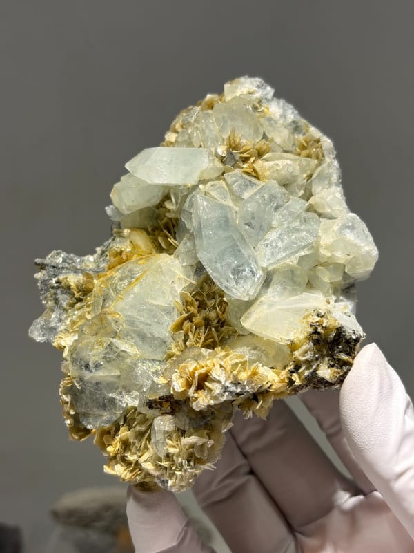 Plate of pale aquamarine crystals on mica from Xuebaoding, Sichuan, China, close-up of the crystal faces