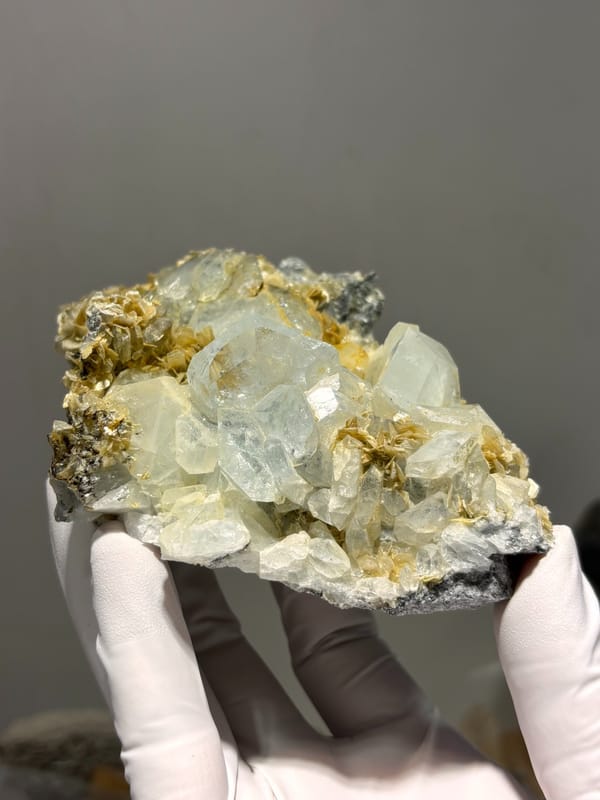 Plate of pale aquamarine crystals on mica from Xuebaoding, Sichuan, China, detail of the matrix contact