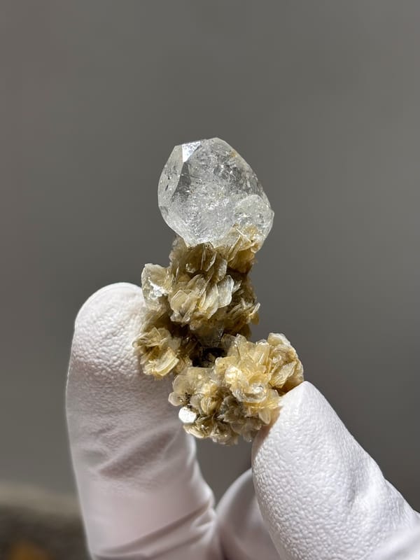 Pale aquamarine crystal on golden mica stalk from Xuebaoding, Sichuan, China, second angle