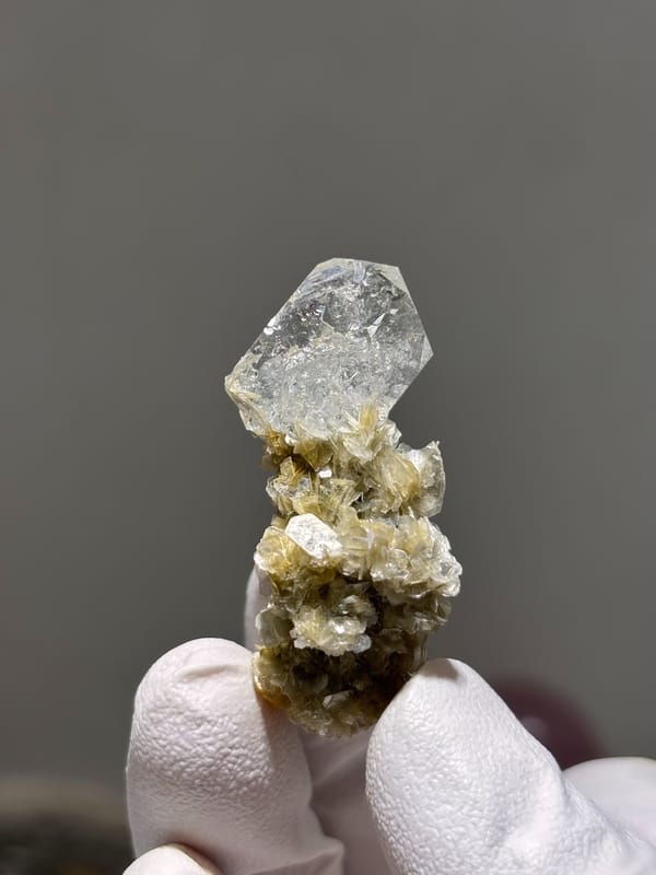 Pale aquamarine crystal on golden mica stalk from Xuebaoding, Sichuan, China, reverse side
