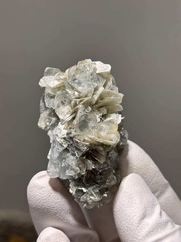 Pale aquamarine crystal capping tan mica stack from Xuebaoding, Sichuan, China, view 3 of 5