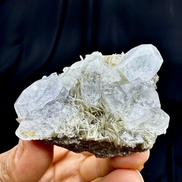 Pale aquamarine prism on muscovite needles from Xuebaoding, Sichuan, China