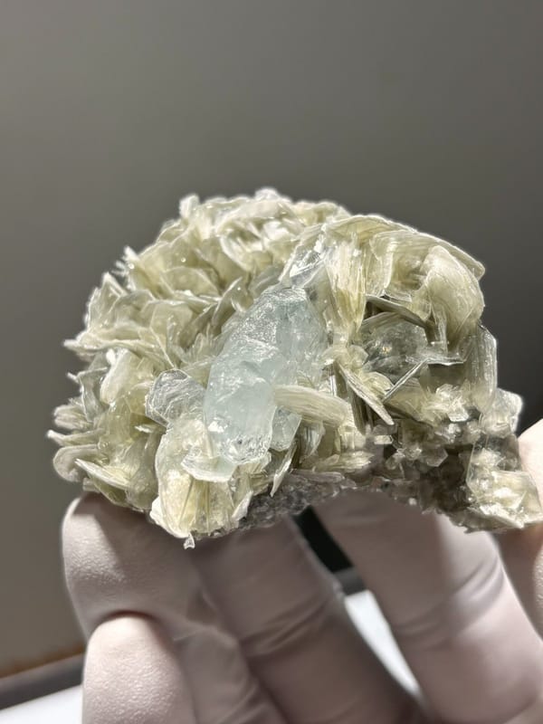 Pale aquamarine set in mica rosette from Xuebaoding, Sichuan, China, view 2 of 5