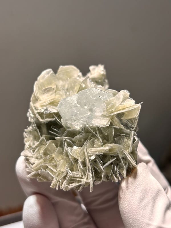 Pale aquamarine set in mica rosette from Xuebaoding, Sichuan, China, view 4 of 5