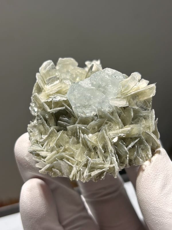 Pale aquamarine set in mica rosette from Xuebaoding, Sichuan, China, view 5 of 5