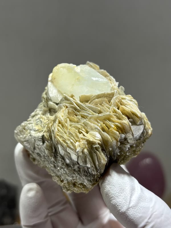 Pale aquamarine crystal nested in mica blades and feldspar from Xuebaoding, Sichuan, China, second angle