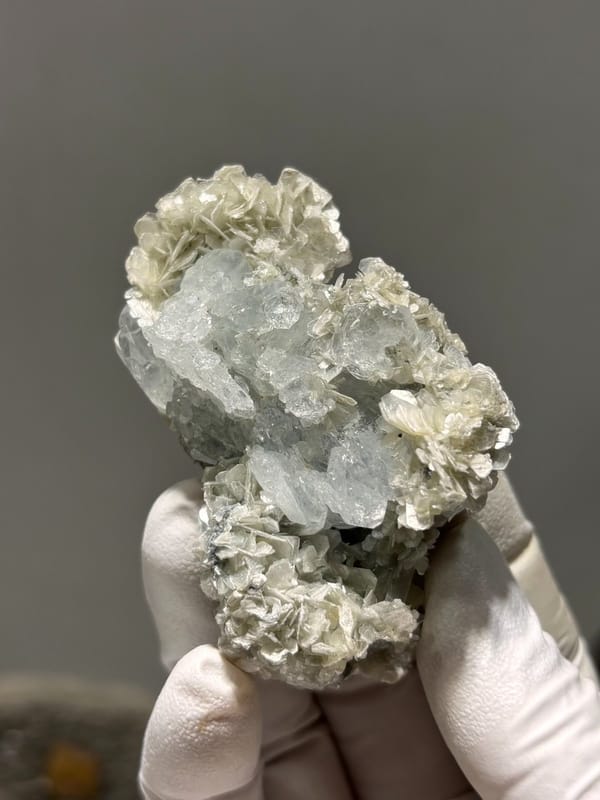 Pale aquamarine block ringed with tan mica rosettes from Xuebaoding, Sichuan, China, view 2 of 6