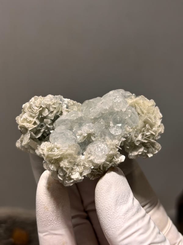 Pale aquamarine block ringed with tan mica rosettes from Xuebaoding, Sichuan, China, view 3 of 6