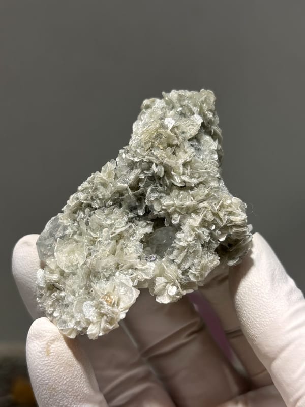 Pale aquamarine block ringed with tan mica rosettes from Xuebaoding, Sichuan, China, view 4 of 6