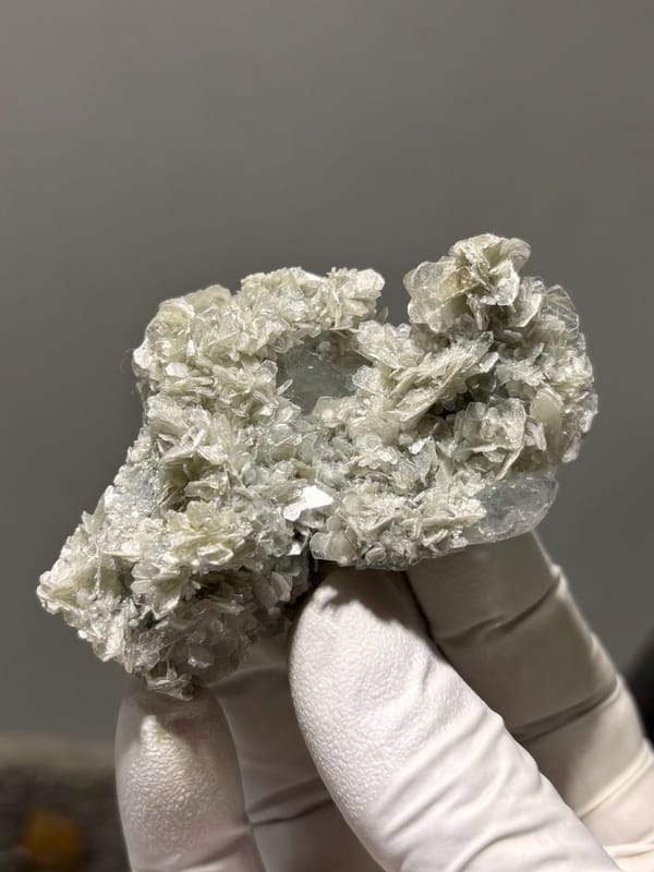 Pale aquamarine block ringed with tan mica rosettes from Xuebaoding, Sichuan, China, view 6 of 6