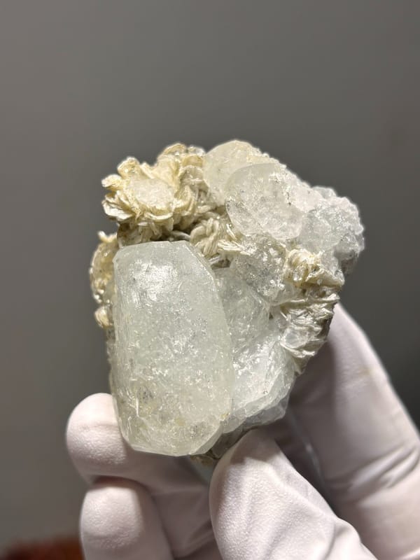 Pale aquamarine on golden mica rosette from Xuebaoding, Sichuan, China, second angle