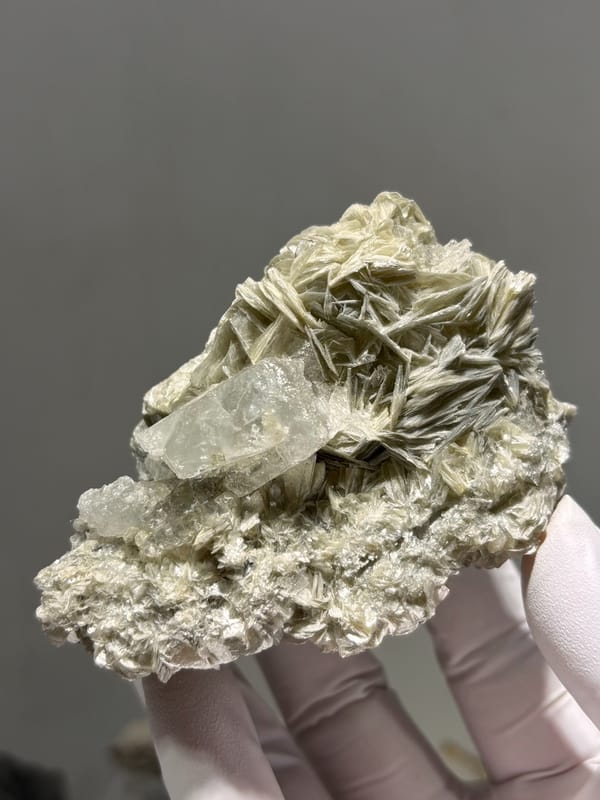 Pale aquamarine on golden mica plate from Xuebaoding, Sichuan, China, close-up of the crystal faces