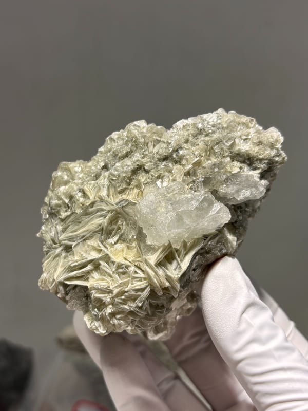 Pale aquamarine on golden mica plate from Xuebaoding, Sichuan, China, top view