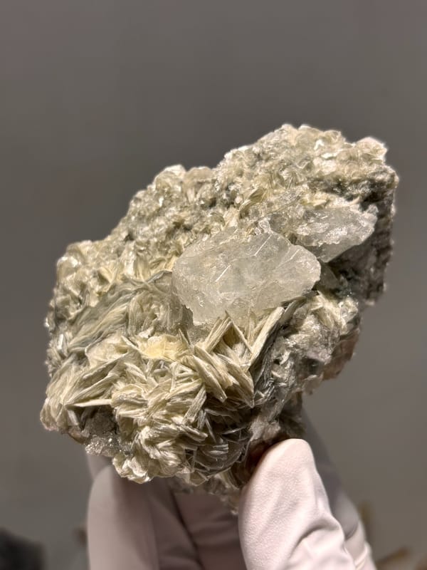 Pale aquamarine on golden mica plate from Xuebaoding, Sichuan, China, detail of the matrix contact