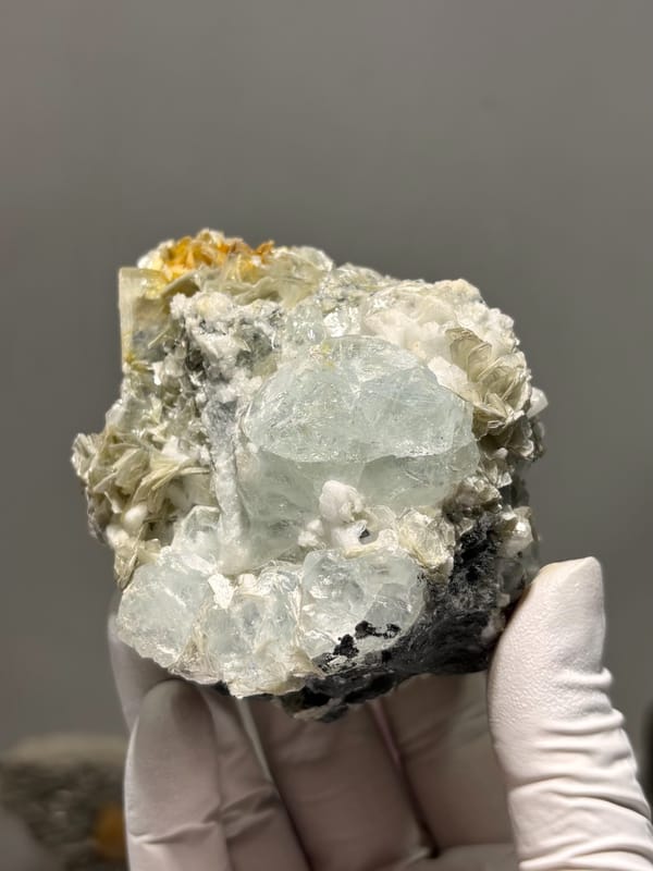 Pale aquamarine cluster with mica, feldspar and cassiterite from Xuebaoding, Sichuan, China, second angle
