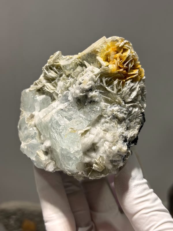 Pale aquamarine cluster with mica, feldspar and cassiterite from Xuebaoding, Sichuan, China, reverse side