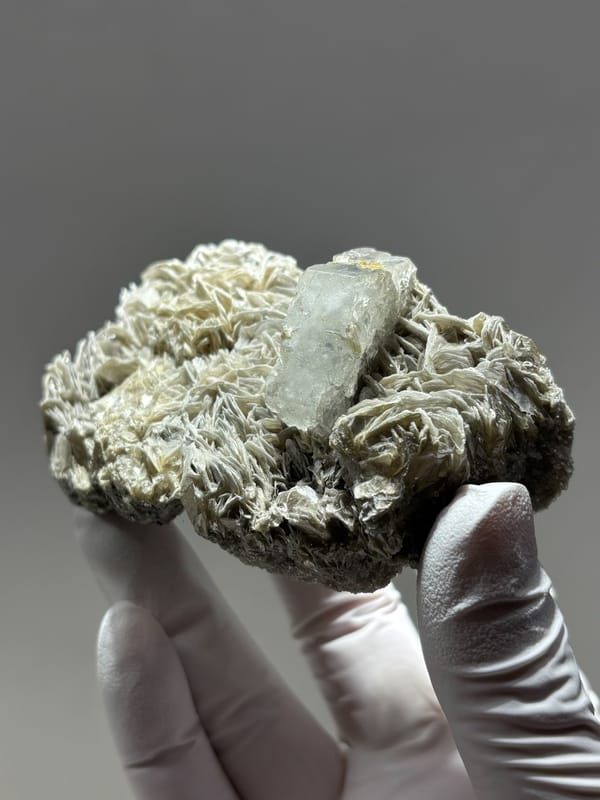 Pale aquamarine capping tall mica block from Xuebaoding, Sichuan, China, close-up of the crystal faces