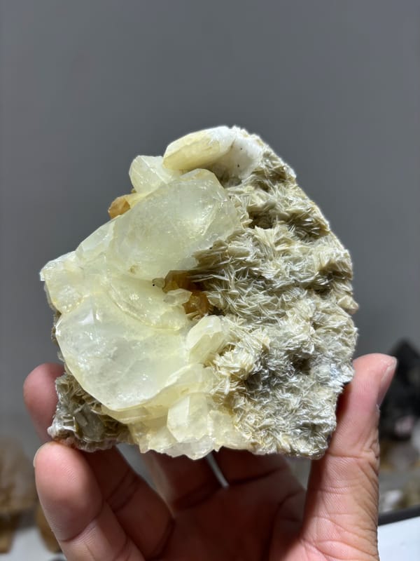 Pale aquamarine crystals over mica-and-scheelite base from Xuebaoding, Sichuan, China, close-up of the crystal faces