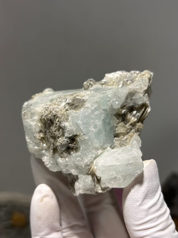 Pale blue aquamarine set in dark mica from Xuebaoding, Sichuan, China, second angle
