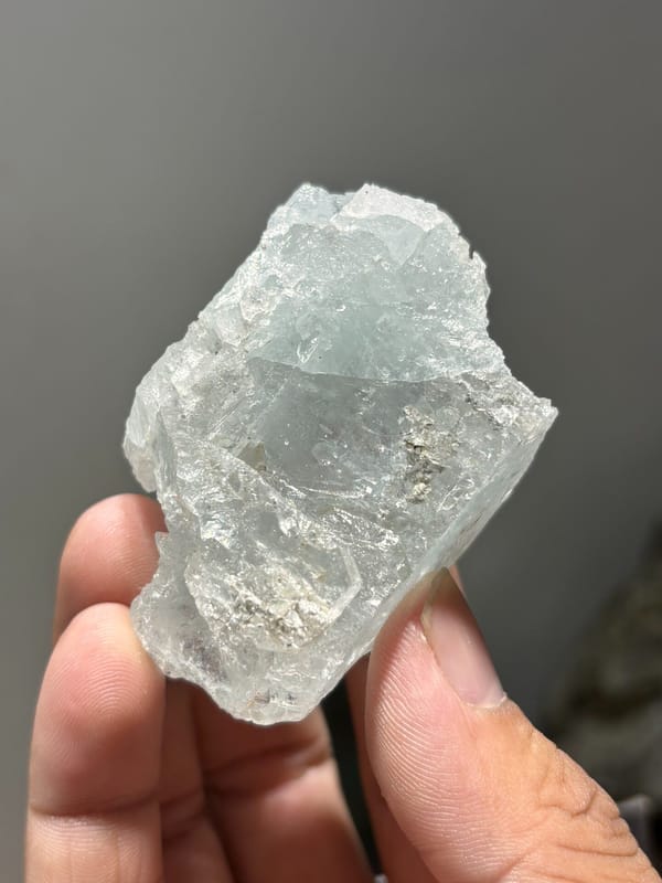 Pale blue aquamarine block with etched faces from Xuebaoding, Sichuan, China, close-up of the crystal faces