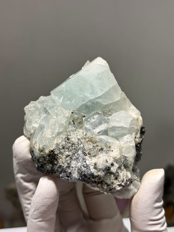 Cluster of pale blue aquamarine crystals on dark matrix from Xuebaoding, Sichuan, China, second angle