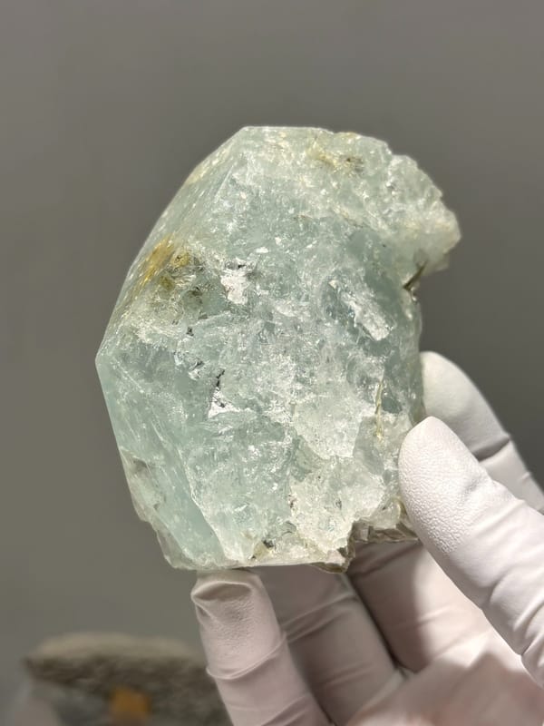 Pale blue-green aquamarine block from Xuebaoding, Sichuan, China, detail of the matrix contact