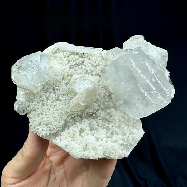Large pale-green apophyllite crystals on white zeolite druse from India