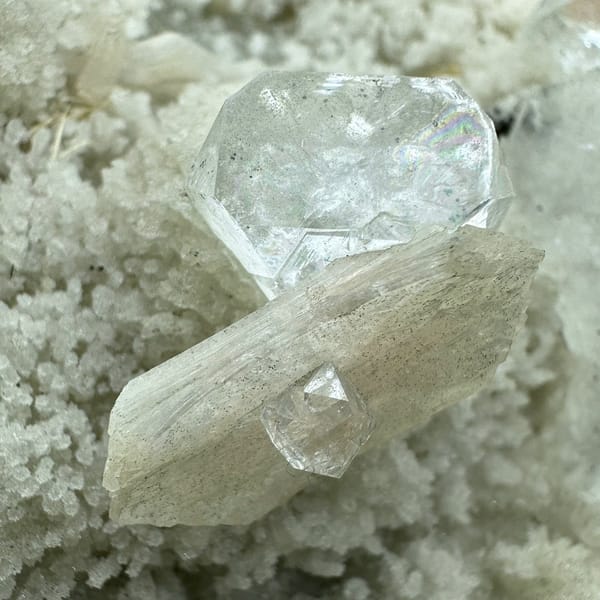 Large pale-green apophyllite crystals on white zeolite druse from India, view 4 of 6