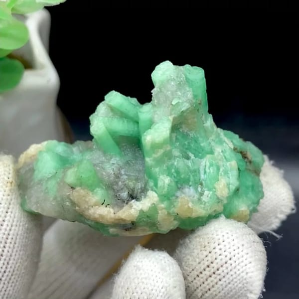 Pale green emerald crystals on rounded beryl matrix from Yunnan, China