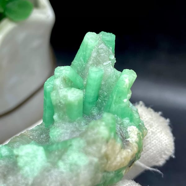 Pale green emerald crystals on rounded beryl matrix from Yunnan, China, view 3 of 9