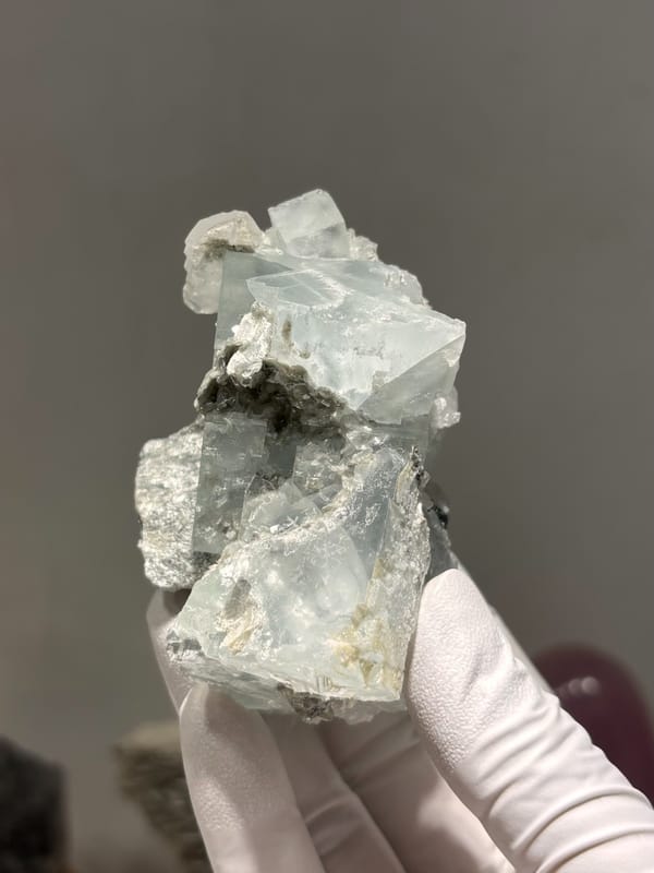 Pale green fluorite cubes with mica and albite from Xuebaoding, Sichuan, China, reverse side