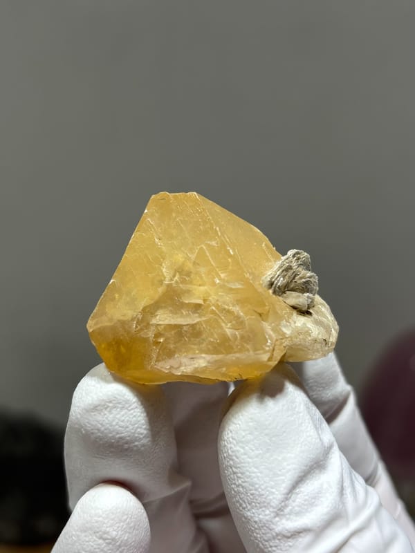 Pale honey scheelite crystal with mica from Xuebaoding, Sichuan, China, second angle