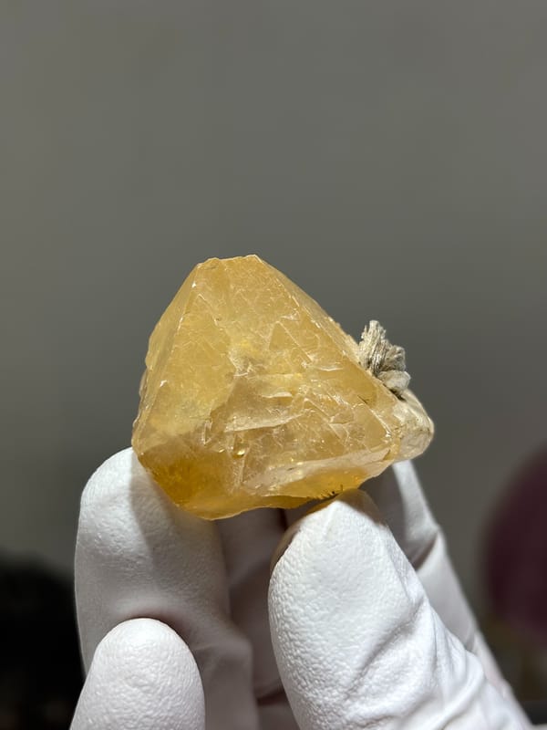 Pale honey scheelite crystal with mica from Xuebaoding, Sichuan, China, reverse side