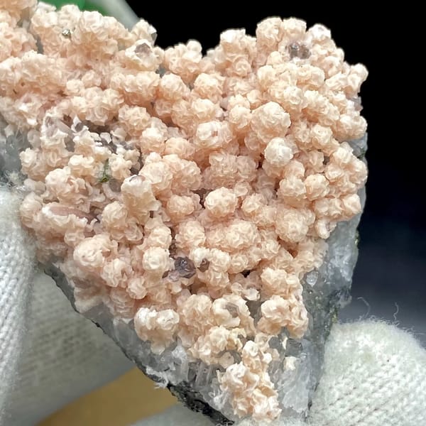 Pale pink botryoidal rhodochrosite over grey quartz from Guangxi, China, view 3 of 9