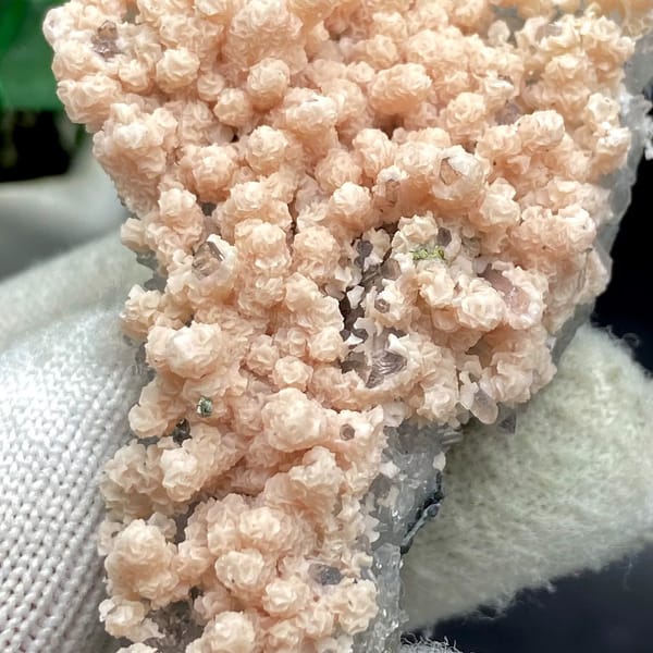 Pale pink botryoidal rhodochrosite over grey quartz from Guangxi, China, view 8 of 9