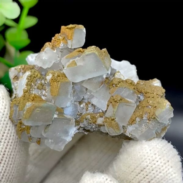 Pale pyramid calcite points with rusty pyrite film from Hunan, China