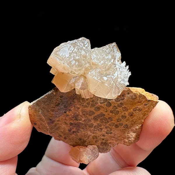 Large peach cerussite crystal on brown matrix from Morocco
