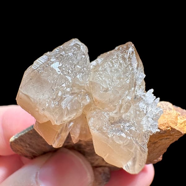 Large peach cerussite crystal on brown matrix from Morocco, view 4 of 6