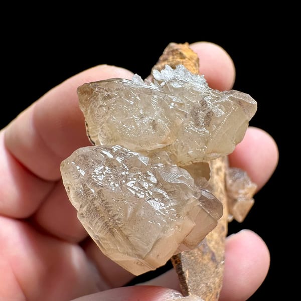 Large peach cerussite crystal on brown matrix from Morocco, view 5 of 6