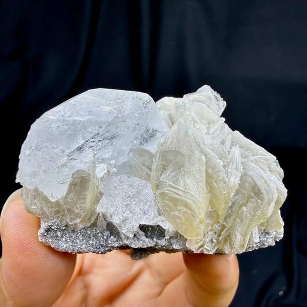 Pearly muscovite books with pale aquamarine crystal from Xuebaoding, Sichuan, China