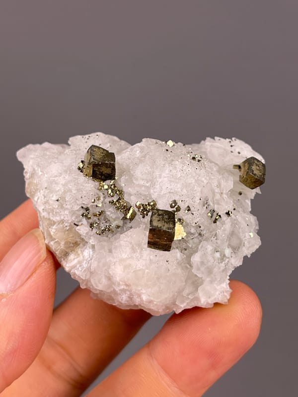 Petal-form Calcite specimen from Longyan, Fujian, China featuring white matrix with sharp pyrite cubes